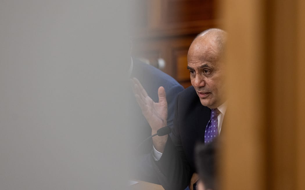 Seen from the corridor, Willie Jackson answer questions from a select committee during the Estimates Hearings 2023.
