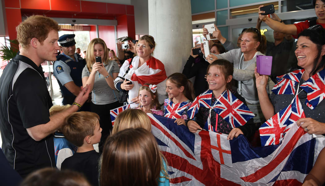 Prince Harry talking to young fans.