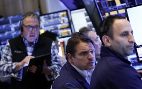 Traders work on the floor of the New York Stock Exchange (NYSE) at the opening bell in New York City, on April 3, 2025. Wall Street stocks sank in early trading on April 3,2025, joining a global equity selloff after President Donald Trump's latest tariff announcement exacerbated worries about a trade war and global economic downturn. (Photo by CHARLY TRIBALLEAU / AFP)