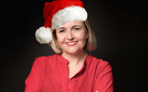 Host Charlotte Ryan in Christmas hat