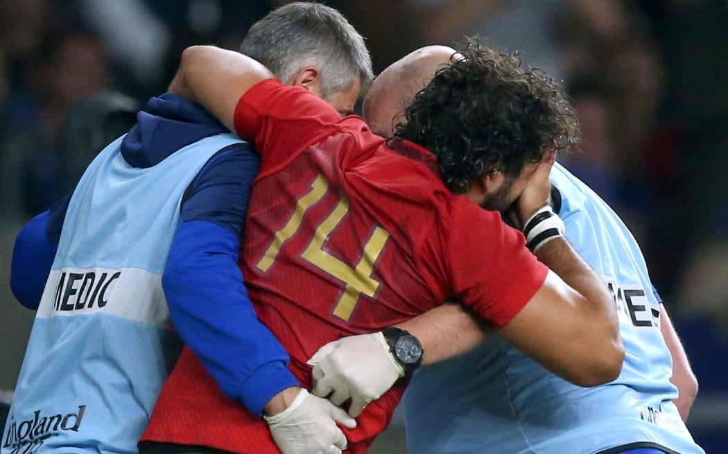 Yoann Huget is carried off during France's win over Italy at the RWC.