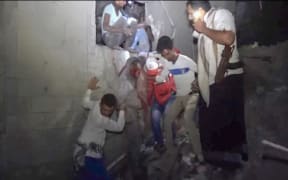 Yemenis rescuing a man from a site following Saudi-led airstrikes on Yemen's rebel-held port city of Hodeidah.