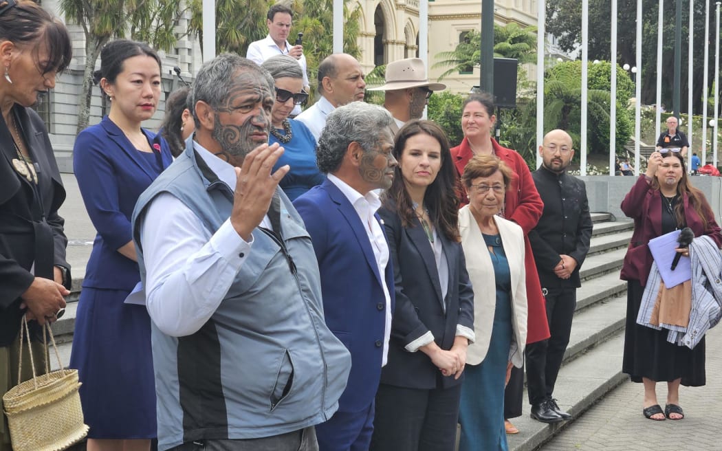 Mātauranga Iwi Leaders Group Chair Rāhui Papa presents a 24,000 strong petition calling for the immediate reversal of the amendment that removed school boards' requirement to give effect to te Tiriti to Minister of Education Erica Stanford.