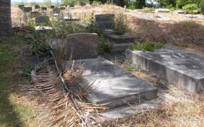 Overgrown graves at Nikao Cemetery in Rarotonga in 2003.
