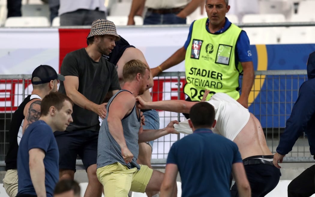 Supporters fight at the end of the Euro 2016 group B football match between England and Russia at the Stade Velodrome in Marseille on June 11, 2016.