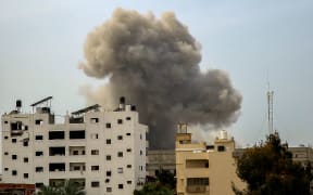 Smoke rises above buildings during an Israeli strike in the vicinity of the al-Shifa hospital in Gaza City on March 28, 2024, amid the ongoing conflict between Israel and the Palestinian Hamas group. (Photo by AFP)