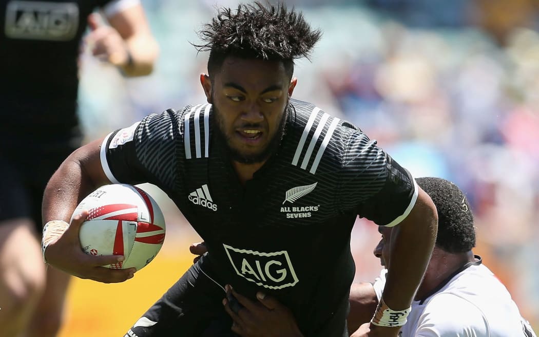 Vilimoni Koroi beats a Fijian tackler.