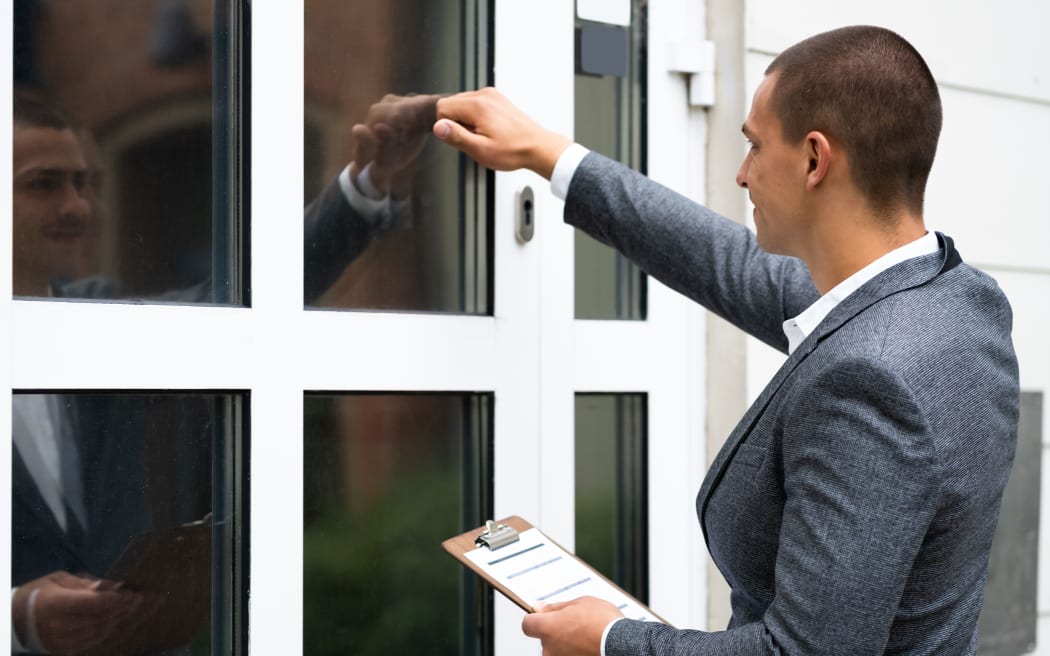 A bailiff knocking on someone's door.