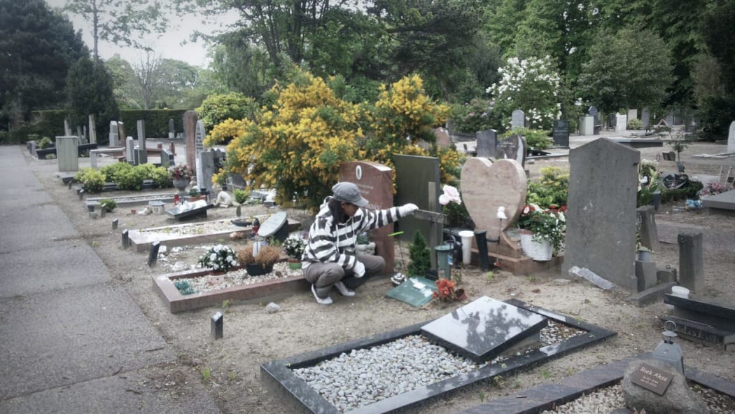 West Papuan Author and Journalist Aprila Wayar grieving at the grave of Seth Jafeth Rumkorem in the Hague.