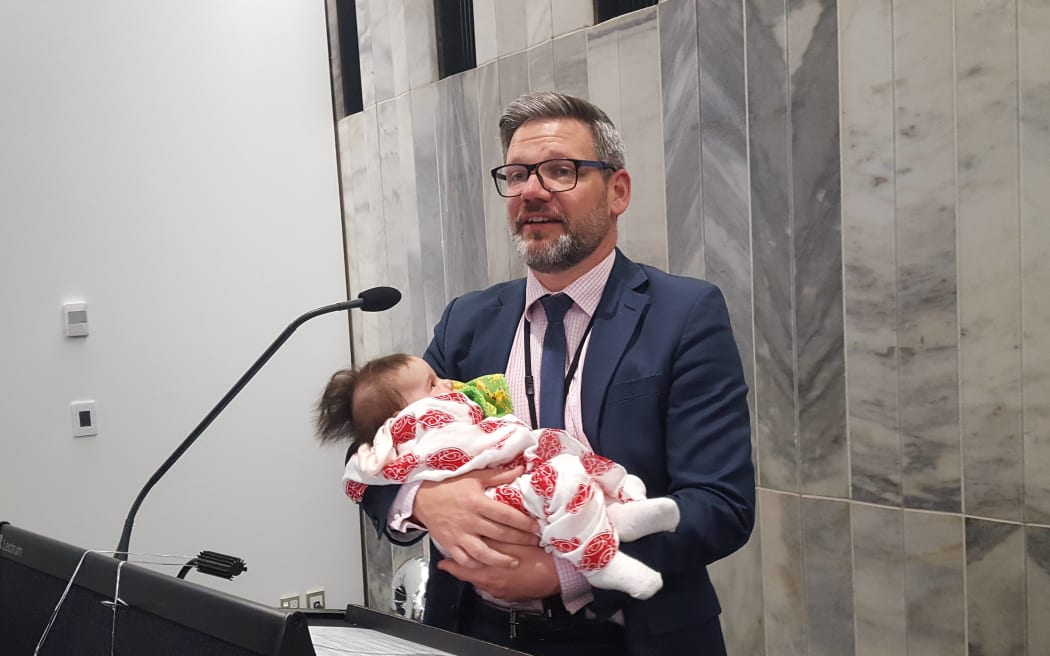 Workplace Relations Minister Iain Lees-Galloway with a baby.