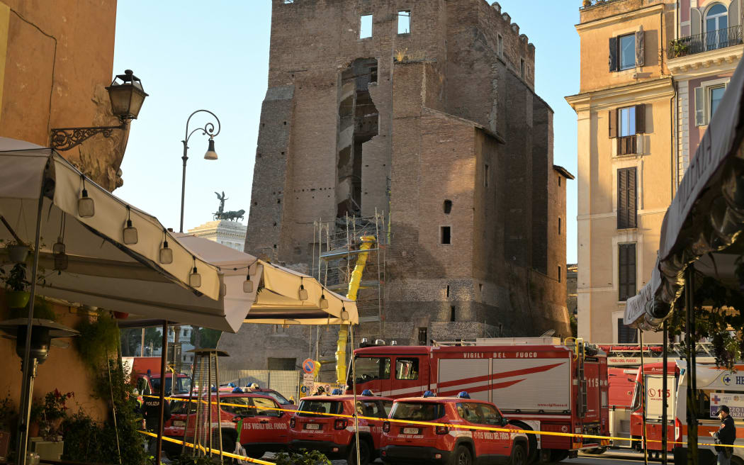Firefighters work on the site after a part of medieval tower "Torre dei Conti" collapses near the Roman Forum in the historic center of Rome on November 3, 2025.