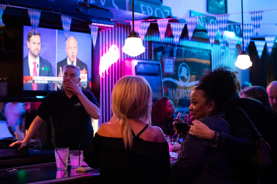 People attend a watch party at Madhatter for the vice presidential debate between Demcocrat Gov. Tim Walz (D-MN) and Republican Sen. J.D. Vance (R-OH) in Washington, DC, on October 1, 2024. (Photo by Allison Bailey/NurPhoto) (Photo by Allison Bailey / NurPhoto / NurPhoto via AFP)