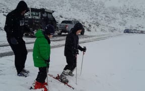 Brothers Lukas, Felix and Archer make the most of being stuck in show on SH73 near Castle Hill on Sunday, 18 August 2024.