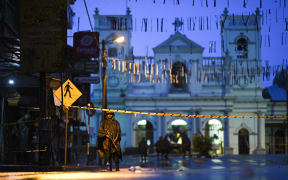 Sri Lankan soldiers stand guard under the rain at St. Anthony's Shrine in Colombo on April 25, 2019, following a series of bomb blasts targeting churches and luxury hotels on the Easter Sunday in Sri Lanka.
