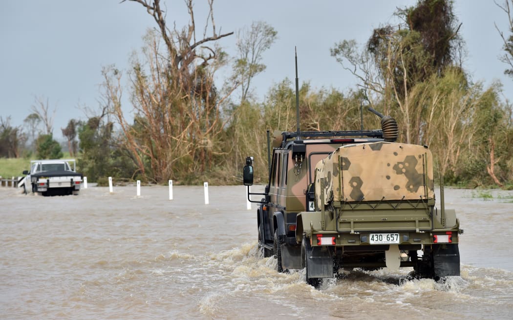 An army vehicle drives through floodwaters near the Queensland town of Bowen on Wednesday.