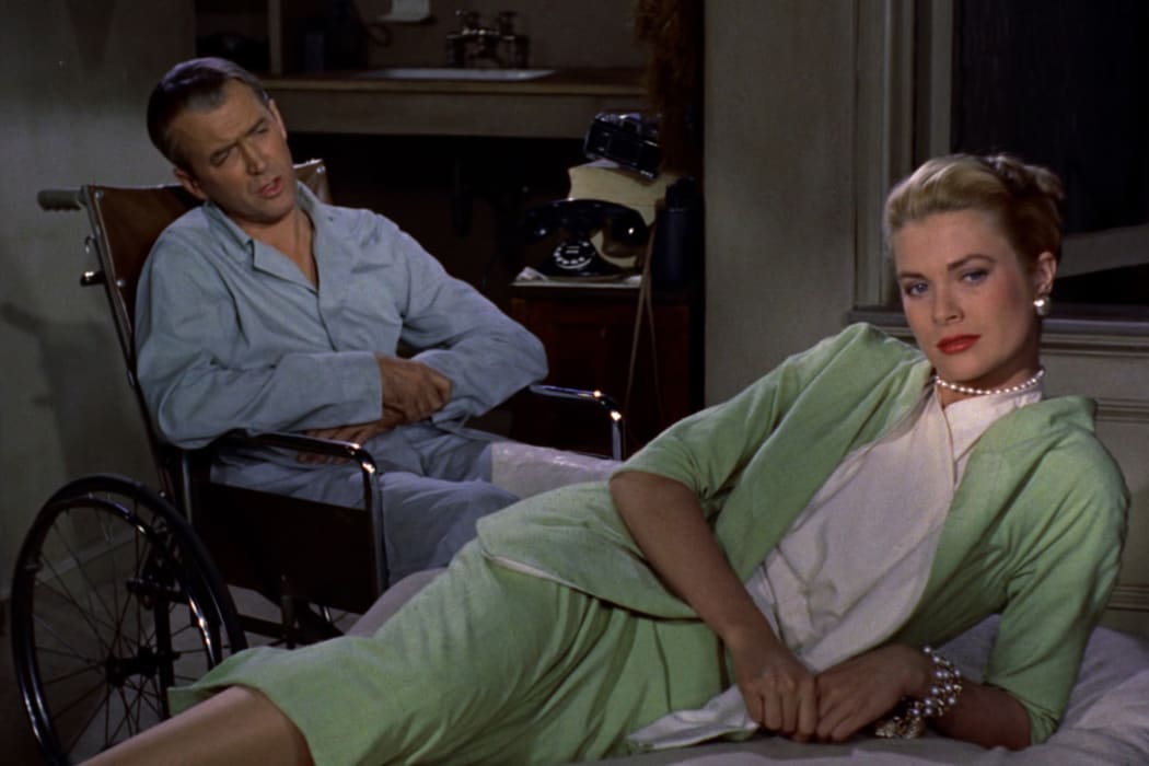 Movie still from the 1954 Alfred Hitchcock thriller Rear Window featuring James Stewart and Grace Kelly