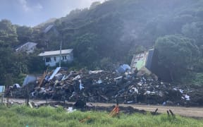Houses came tumbling down hills in an area known as 'The Valley' in Karekare after heavy rain from Cyclone Gabrielle.
