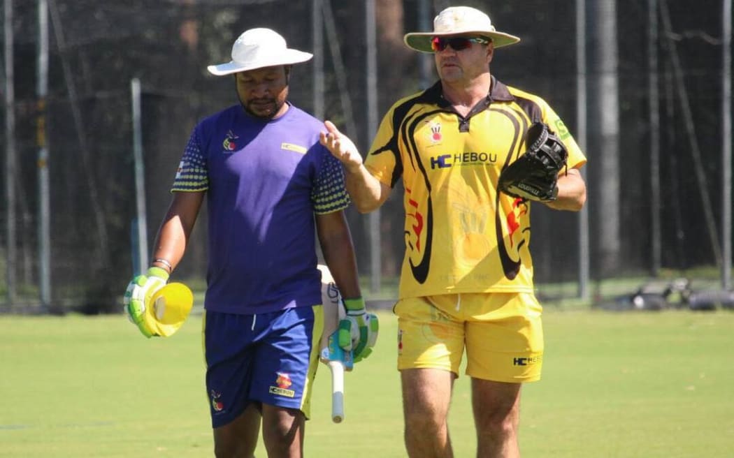 Assad Vala discusses tactics with coach Joe Dawes, (right).