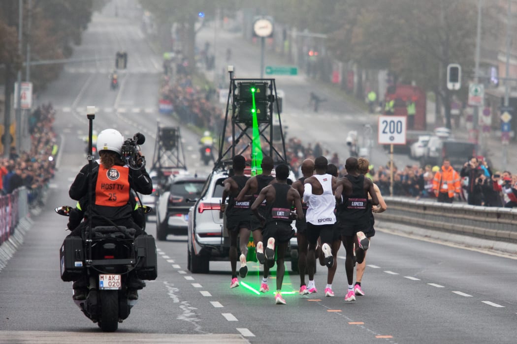 Eliud Kipchoge (white jersey), accompanied by pacemakers follow a laser beam during the Vienna marathon record.