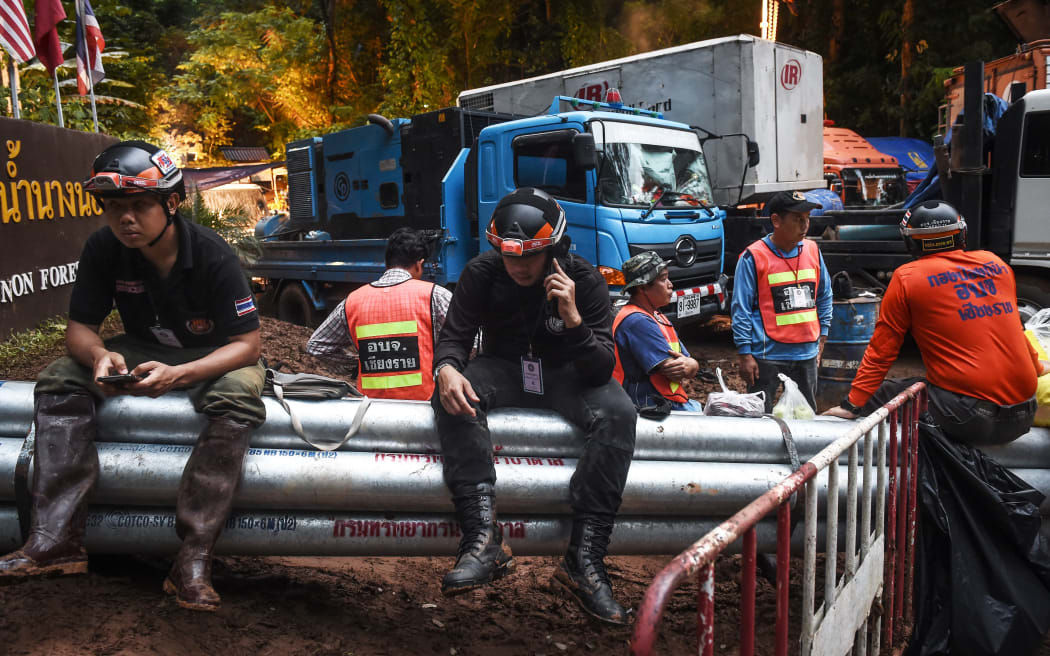 Technicians and engineers rest at one of the water pumping sites near the Tham Luang cave at the Khun Nam Nang Non Forest Park in Chiang Rai province as the rescue operation continues for a missing children's football team and their coach.