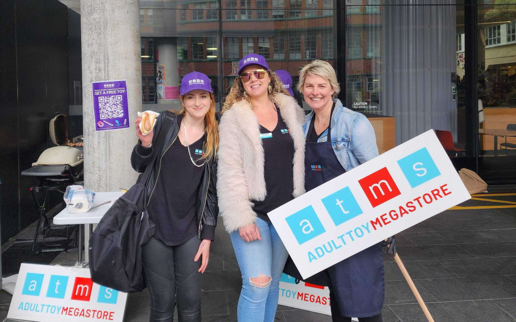 Whitley Mallory, Jules Powell and Nicola Relph from Adulttoymegastore handing out free condoms at a Victoria University campus sausage sizzle.