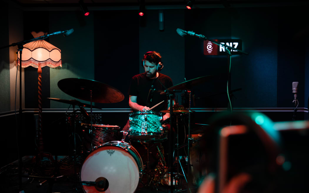 Julian Dyne, drummer in the band Half Hexagon, performing live in the RNZ Auckland studio