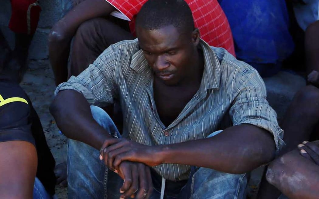 An illegal migrant rests after being rescued by the Libyan coastguard.
