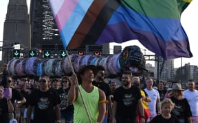 People participate in the Pride March event over the Harbour Bridge in Sydney on March 5, 2023. (Photo by Saeed KHAN / AFP)