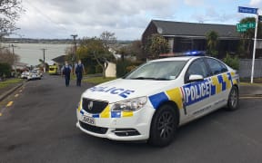 Police on Lilac Grove, Hillsborough, after a person in possession of a firearm was shot by police and is in a serious condition following a chase that ended on the street.