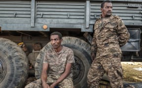 Ethiopian soldiers rest in front of the entrance to the 5th Battalion of the Northern Command of the Ethiopian Army in Dansha, Ethiopia, on November 25, 2020.