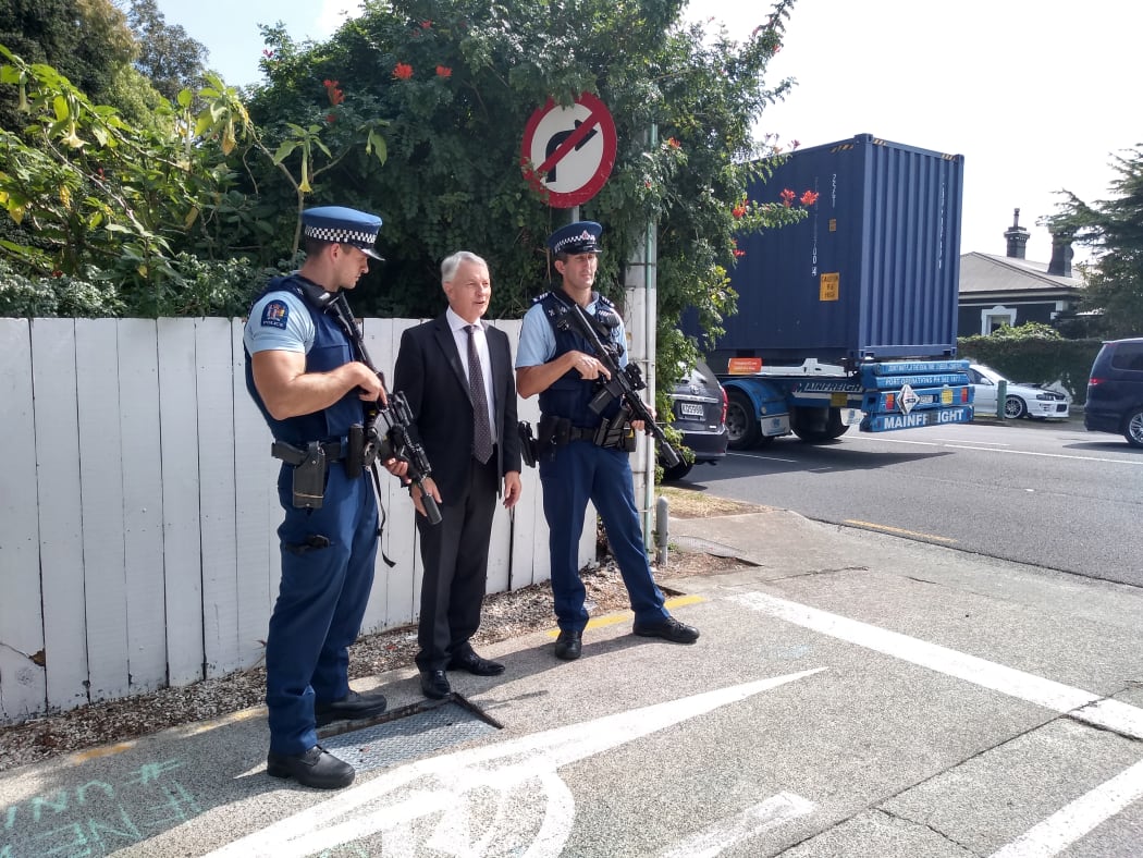 Phil Goff with armed police officers at Otahuhu.