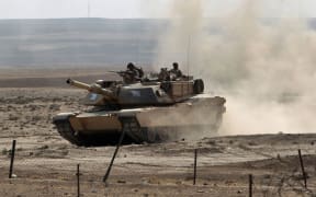 Iraqi government forces enter the village of al-Khuwayn, south of Mosul, after recapturing it from Islamic State (IS) group jihadists on October 23, 2016,