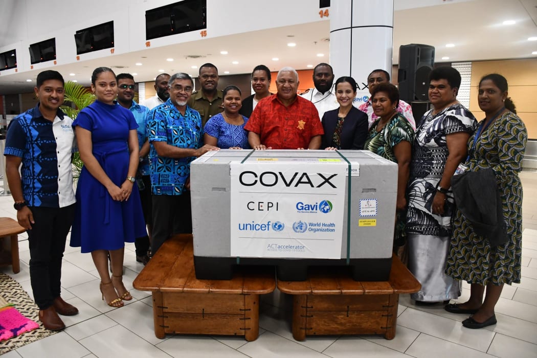 Fiji's Prime Minister Frank Bainimarama, centre, with health officials at Nadi Airport.