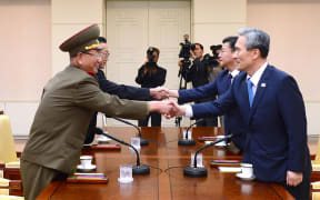 South Korean president's national security adviser, Kim Kwan-Jin (right), and unification minister Hong Yong-Pyo (2nd R) shaking hands with the North Korean military's top political officer Hwang Pyong-So (left) and North Korean top official in charge of South Korea affairs, Kim Yang-Gon (2nd L).