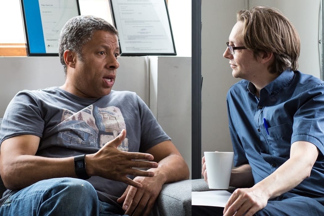 Two men talking in a waiting room