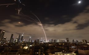 Israeli air defence systems are activated to intercept Iranian missiles over the Israeli city of Tel Aviv amid a fresh barrage of Iranian rockets on June 16, 2025. The Israeli military said early on June 16 that it was striking surface-to-surface missile sites in Iran, its latest move in three days of escalating conflict between the rival states. "The IDF is currently striking surface-to-surface missile sites in central Iran," Israel Defense Forces (IDF) spokesman Nadav Shoshani wrote on X. "We are operating against this threat in our skies and in Iranian skies." (Photo by Menahem Kahana / AFP)