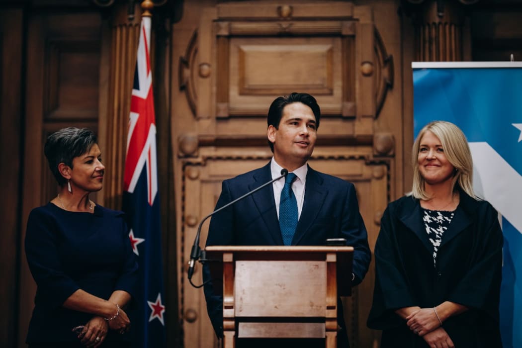Outgoing National leader Simon Bridges, flanked by his deputy leader Paula Bennett and his wife Natalie Bridges, gives his resignation speech.