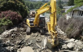 Diggers work in Roxburgh's Reservoir Creek drainage in a race against time before next the downpour.