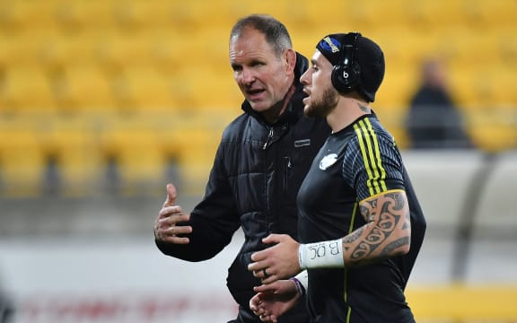 Hurricanes head coach John Plumtree  speaks with TJ Perenara.