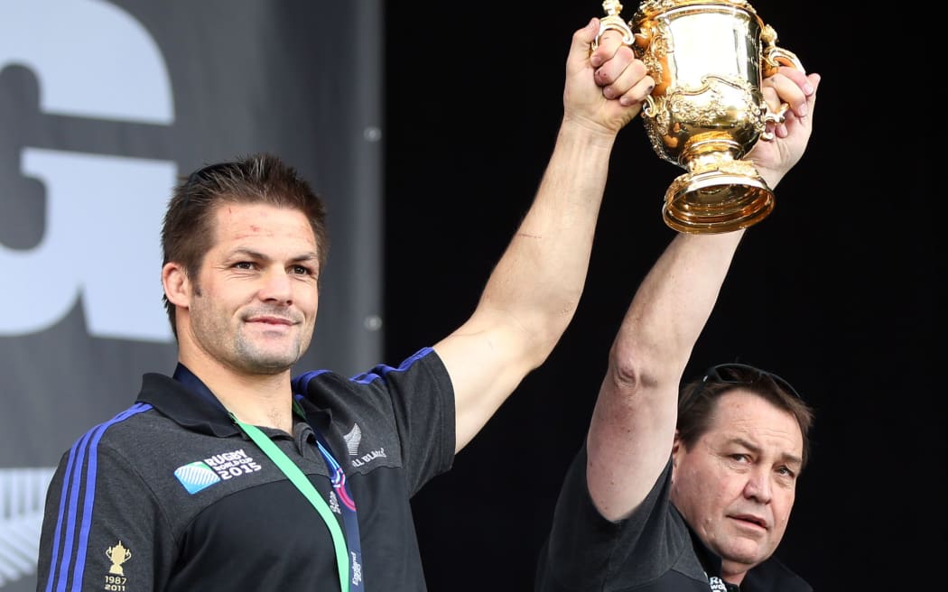 All Black captain Richie McCaw and coach Steve Hansen hold the world cup high during the official Auckland celebrations.