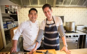 Lek and Wallace as Wallace learns to cook Thai noodles in Saan restaurant.