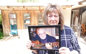 Christine Toms, with a picture of husband Arthur, says she's in limbo while she waits for answers about his death.