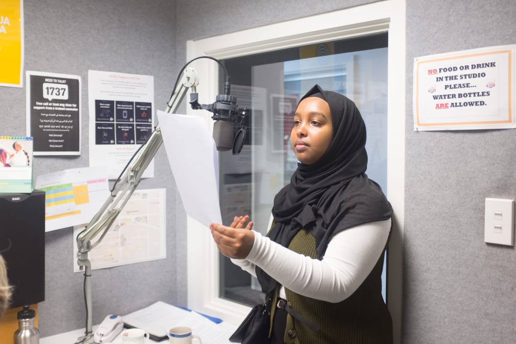 Reading a script during the post-production of the Widows of Shuhada. With Asha Abdi at  Plains FM radio station, Christchurch, New Zealand.