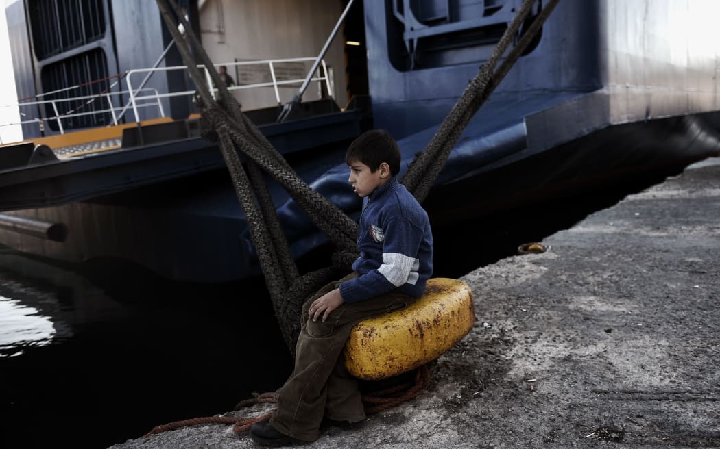 A boy waits at the port of Lesbos Island due to a strike of Greece's seamen's federation on November 4, 2015 in Mytilene.