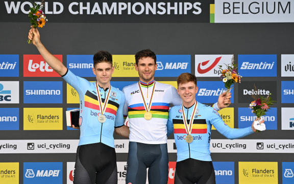 (From L) Belgian Wout Van Aert, Italian Filippo Ganna and Belgian Remco Evenepoel pose on the podium after the time trial race as part of the Men's Elite as part of the UCI World Championships Road Cycling Flanders 2021, in Bruges, on September 19, 2021.