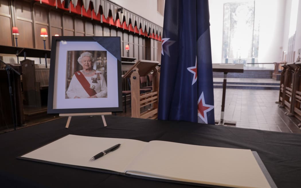 People fill out messages of condolences in a book at St Paul's Church Auckland after the death of Queen Elizabeth II, on 9 September, 2022.