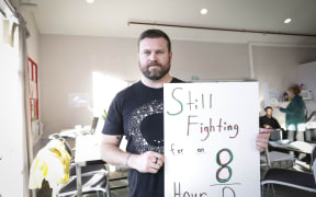 Teacher Matt Boucher with his banner.