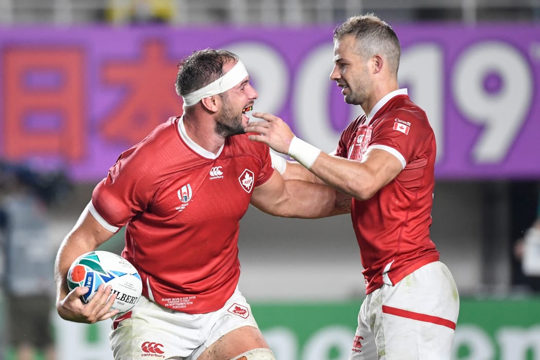 Canada's number 8 Tyler Ardron (L) celebrates his try that was later disallowed with Canada's scrum-half Gordon McRorie during the Japan 2019 Rugby World Cup Pool B match between Italy and Canada at the Fukuoka Hakatanomori Stadium in Fukuoka on September 26, 2019. (Photo by CHRISTOPHE SIMON / AFP)
