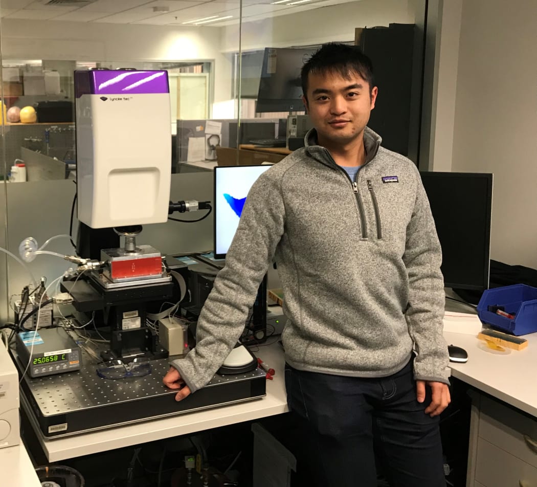 Dixon Leung of Auckland Bioengineering Institute next to some of the profilometer equipment to test the sensor membrane.