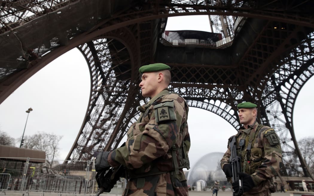 French soldiers patrol in front of the Eiffel Tower following the Paris shooting.
